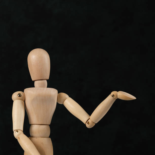 Handcrafted wooden man figure mannequin model dummy doll on background. Copy space.