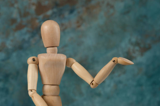 istock Handcrafted wooden man figure mannequin model dummy doll on background. Copy space. 1253236586