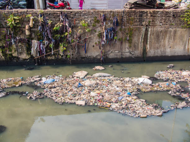 istock Dirty river in Dharavi slums. Mumbai. India 1253236672