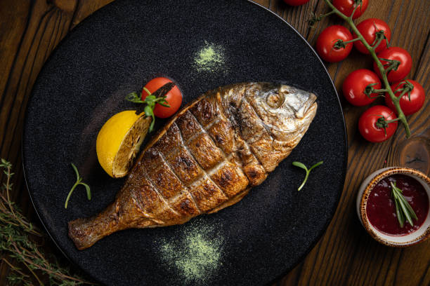 istock dorada grilled on plate with vegetables 1253237597