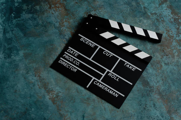istock Clapper board with popcorn. Movie concept. Clapperboard on a textural background. Close-up. Copy space. 1253237799