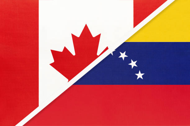 istock Canada and Venezuela, symbol of national flags from textile. Championship between two American countries. 1253238271