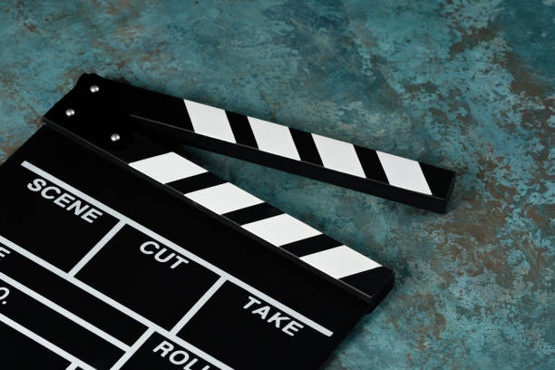 istock Clapper board with popcorn. Movie concept. Clapperboard on a textural background. Close-up. Copy space. 1253238299