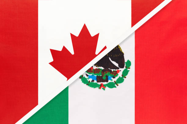 istock Canada and Mexico, symbol of national flags from textile. Championship between two American countries. 1253239119