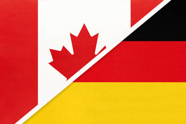 istock Canada and Germany, symbol of national flags from textile. Championship between two countries. 1253239282