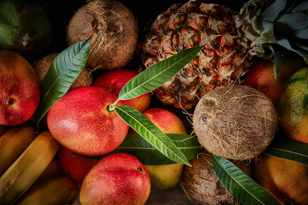 istock Group of ripe tropical fruits on a table in a rustic kitchen 1253242032