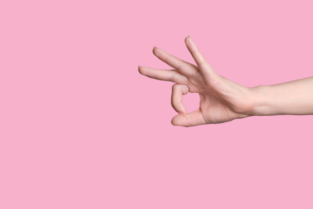 istock Close-up gesture ok, super. Caucasian hand. Pink background. 1253246348