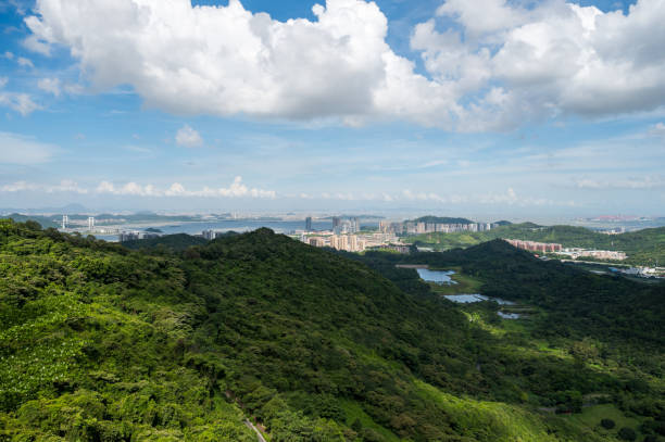 istock Mountain climbing overlooking the city 1253246742