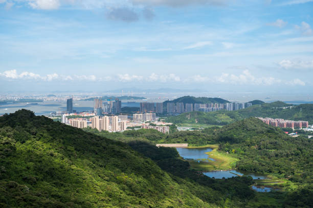istock Mountain climbing overlooking the city 1253246745