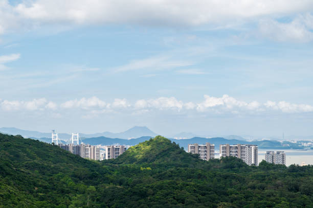istock Mountain climbing overlooking the city 1253246749