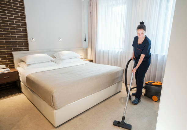 istock Maid vacuuming hotel room 1253246819