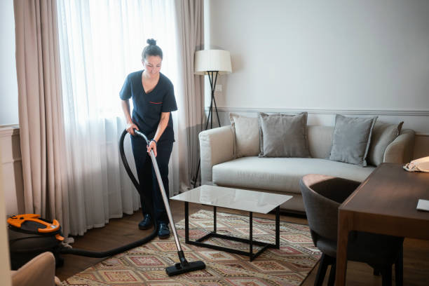 istock Maid vacuuming hotel room 1253246928
