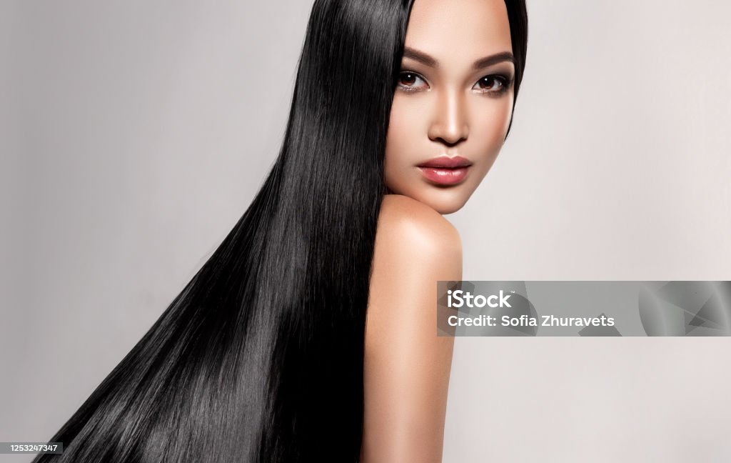 Black Haired Young Woman With Asian Appearance Is Demonstrating Dense Well  Cared Straight Hair Asian Beauty Stock Photo - Download Image Now - iStock