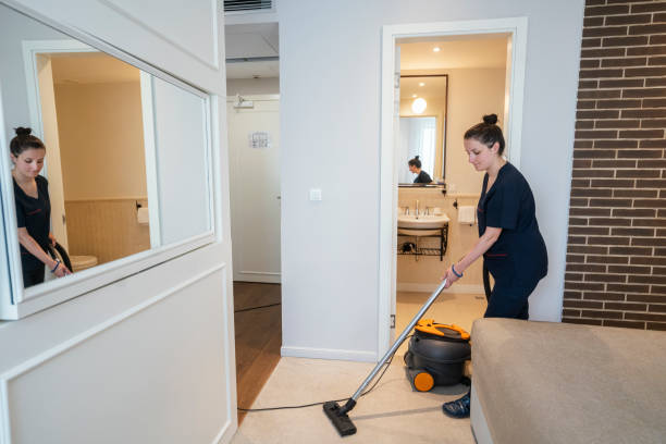 istock Maid vacuuming hotel room 1253247549
