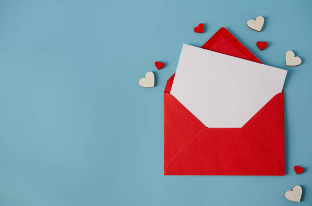 istock Valentines day greeting card. Red envelope with blank card on blue background. 1253248008
