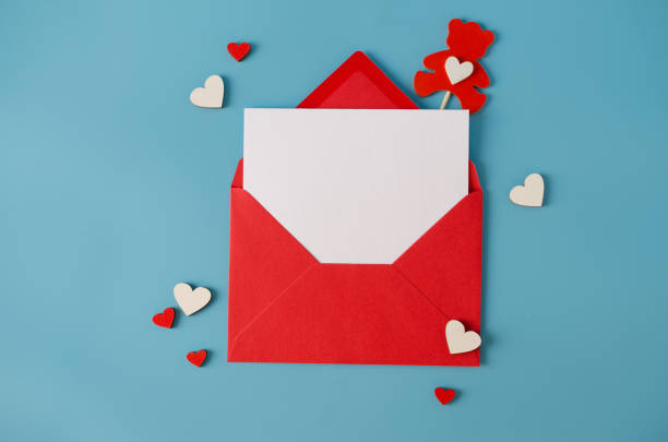 istock Valentines day greeting card. Red envelope with blank card. Top view with space for your greetings. 1253248128