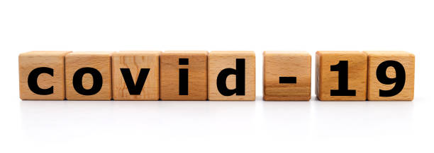 istock Inscription COVID-19 from wooden cubes. 1253250711