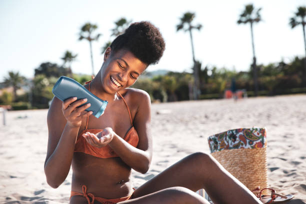 istock Woman sunbathing at the beach 1253250856