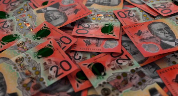 Scattered Australian Dollar Banknote Pile A close-up view of a scattered pile of australian dollar banknotes - 3D render australian dollar stock pictures, royalty-free photos & images