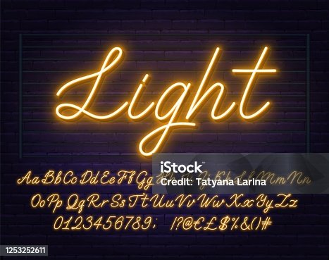 istock Neon yellow script font. Glowing alphabet with letters, numbers and special characters. 1253252611