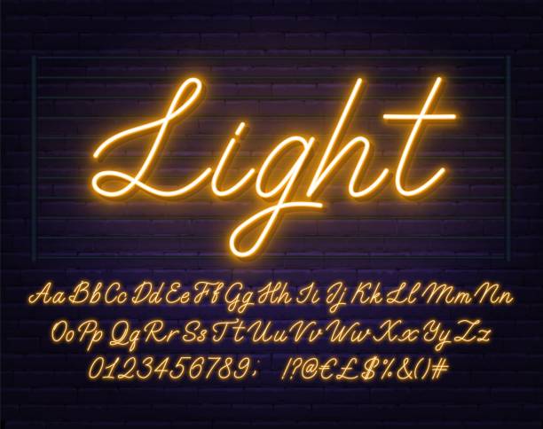 Neon yellow script font. Glowing alphabet with letters, numbers and special characters. Neon yellow script font. Glowing alphabet with letters, numbers and special characters on a brick background. neon lighting stock illustrations