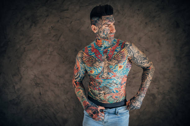 istock Young man with whole body covered in tattoos 1253252650