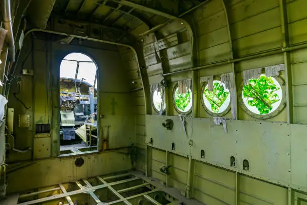 View of cockpit and cabin of old ruined aircraft Antonov An-2 at abandoned Airbase aircraft cemetery