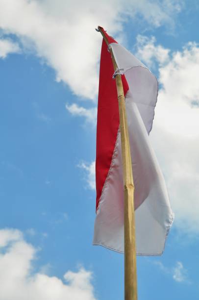 istock Indonesian Flag waving on blue sky background 1253253157