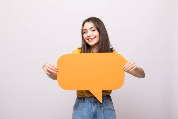 istock Young beautiful girl holding a speech bubble for text, isolated on a white background 1253254208