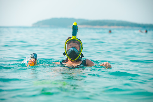 woman in snorkeling mask in sea water copy space