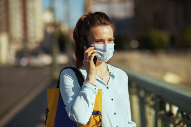 istock stylish female in blue blouse using phone outdoors in city 1253255702