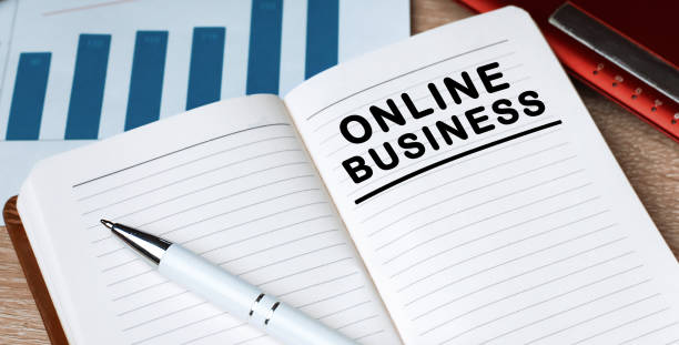 istock Notebook with text ONLINE BUSINESS. Notebook on desk with graph and a pen. 1253255721