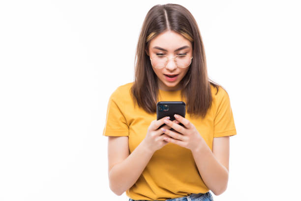 istock Beauty young woman using and reading a smart phone isolated on a white background 1253255769