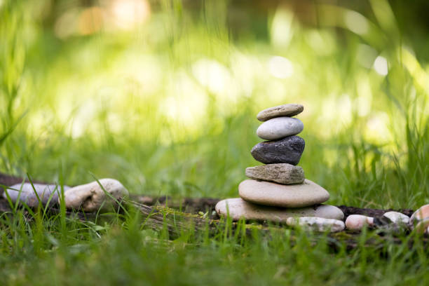 Spirituality: Stone cairn in the park. Balance and relaxation. Close up of stone cairn, metaphor for balance, spirituality and relaxation cairn stock pictures, royalty-free photos & images
