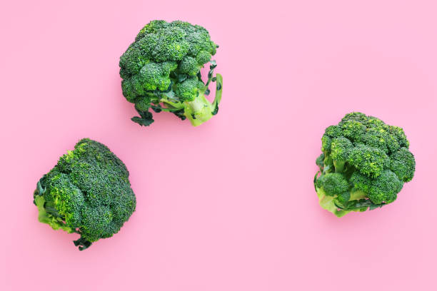 istock Fresh green broccoli on pink background 1253256309