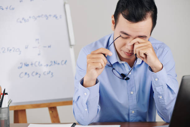 istock Teacher rubbing tired eyes 1253256314