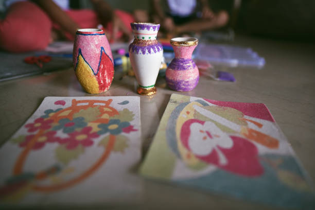 This detailed shot shows the top part of a brightly decorated bottle, featuring a rustic rope-wrapped neck and a small seashell accent.
