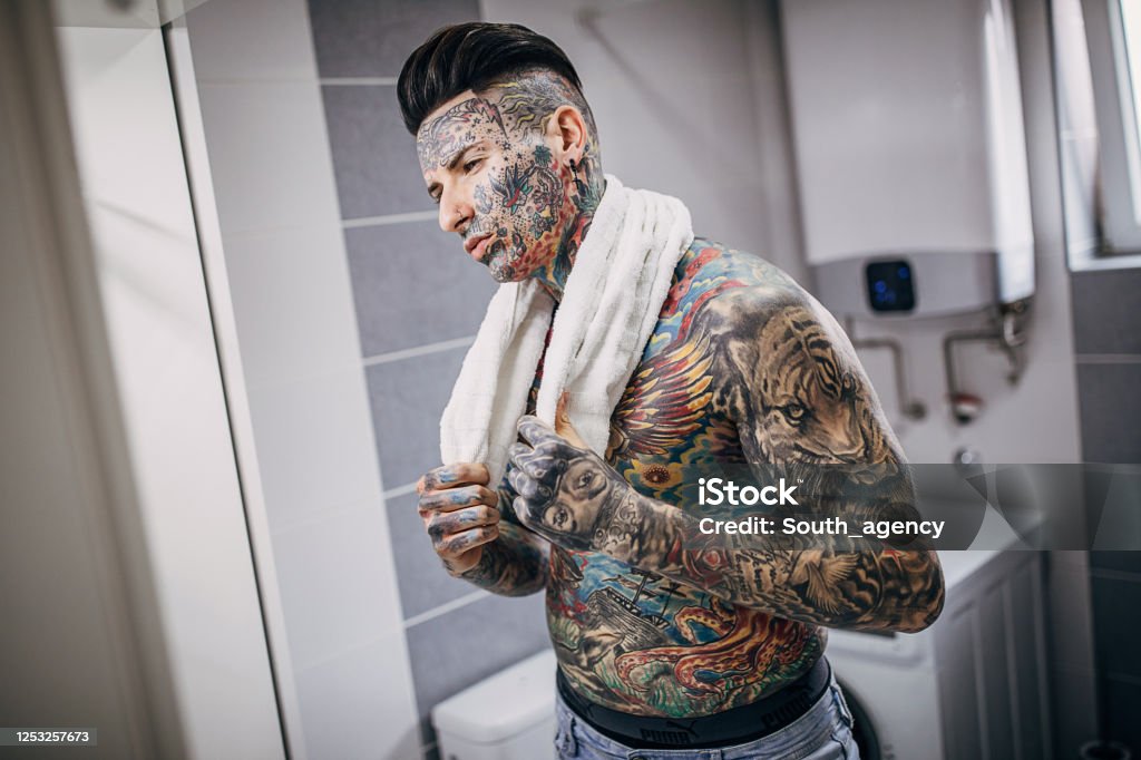 Man With Whole Body Covered In Tattoos Looking Into Bathroom Mirror Stock  Photo - Download Image Now - iStock