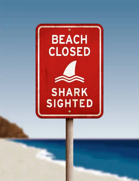 Vector illustration of Red 'beach closed_shark sighted' warning sign on defocused sea background