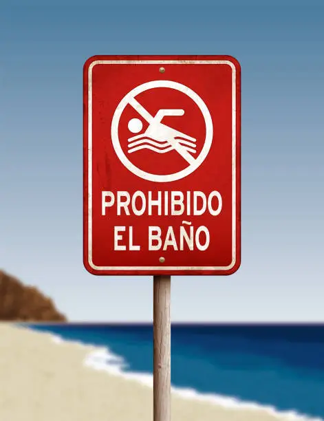 Vector illustration of Weathered 'no swimming' warning sign on blurred beach background
