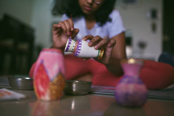 Well-used art brushes, paint cans and drawing pencils stored in paint-stained jars, capturing the creative atmosphere of a working artist’s studio.