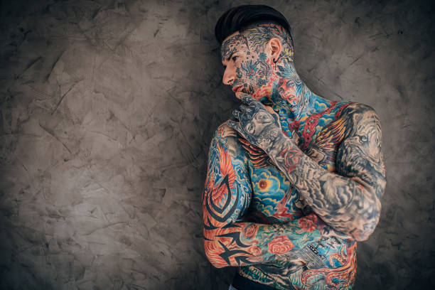 istock Man with whole body covered in tattoos 1253260402