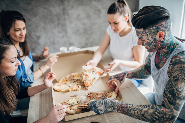 istock Group of friends eating pizza 1253260867