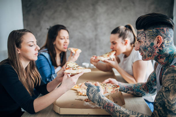 istock Group of friends eating pizza 1253261401
