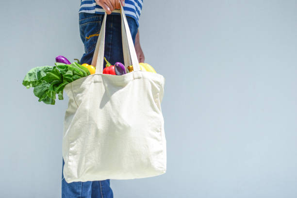 istock Asian Man with reusable grocery bag 1253261407