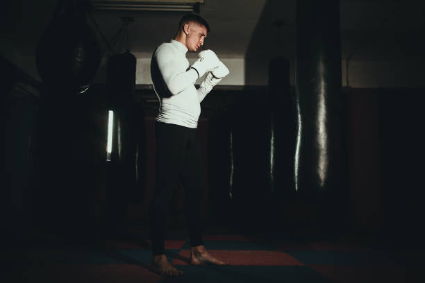istock Young kick boxer in the gym 1253263910