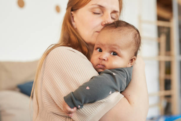 istock Loving Mother Holding Baby 1253263943