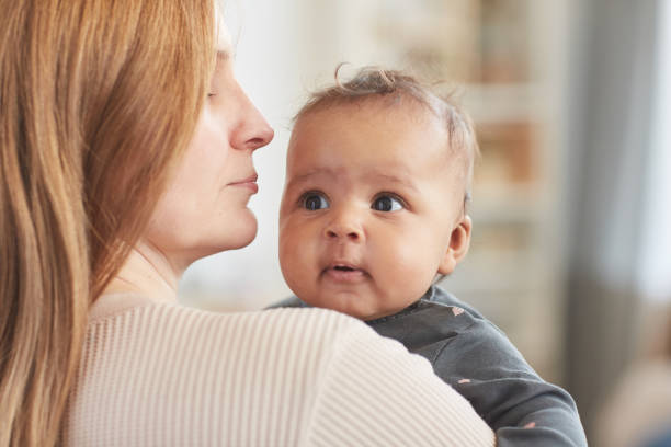 istock Mother Holding Mixed-Race Baby 1253263984