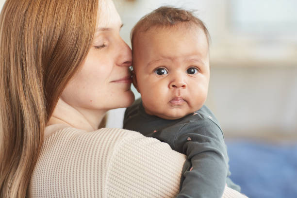istock Loving Mother Holding Mixed-Race Baby 1253263986