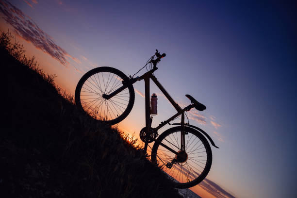 istock silhouette of a bicycle on the sunset sky 1253265397